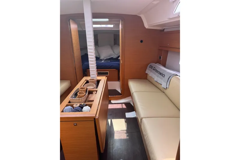 Slide: The Image of 2023 Dufour 37 yacht interior with cozy seating and elegant wood finish. - 15