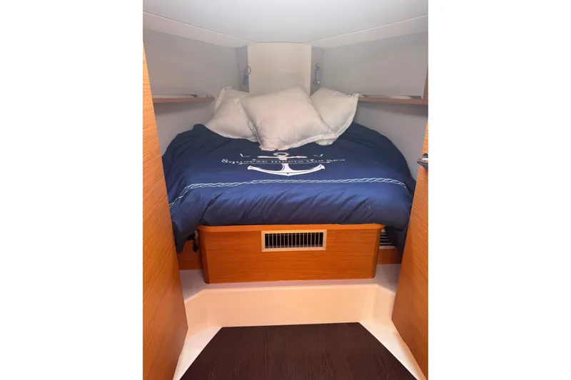 Slide: The Image of Cozy cabin interior of 2023 Dufour 37 yacht with nautical bedding. - 16