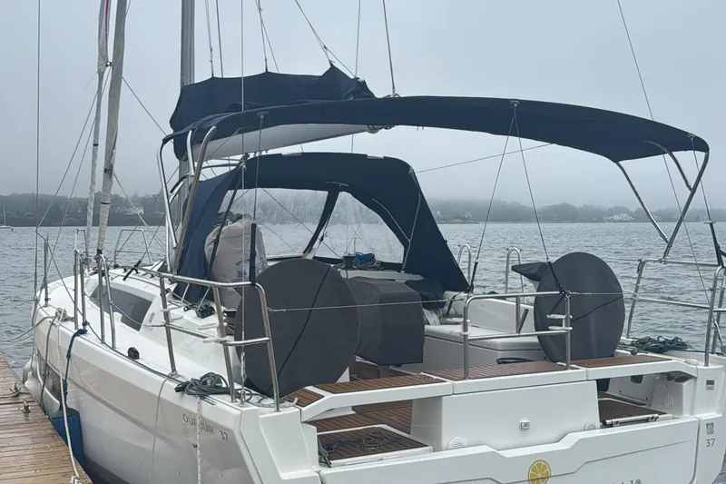 Slide: The Image of 2023 Dufour 37 sailboat docked on a misty lake. - 2