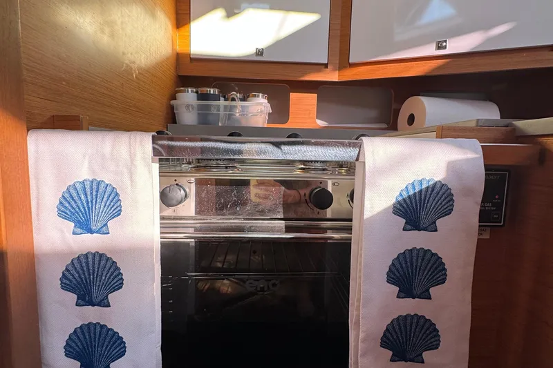 Slide: The Image of Cozy kitchen in 2023 Dufour 37 yacht with seashell-themed towels and modern appliances. - 20