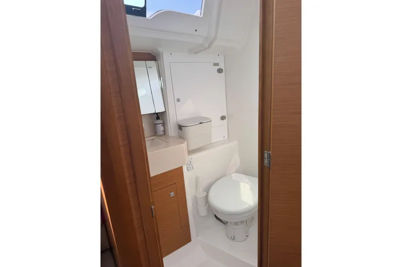 Slide: The Image of 2023 Dufour 37 yacht bathroom with modern fixtures and wooden accents. - 21