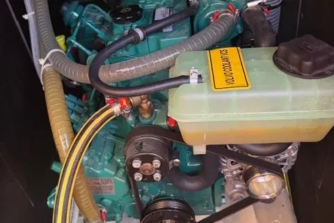 Slide: The Image of Engine compartment of 2023 Dufour 37 sailboat, featuring coolant system and hoses. - 25