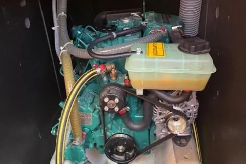 Slide: The Image of Engine compartment of a 2023 Dufour 37 sailboat, showcasing mechanical components and hoses. - 26