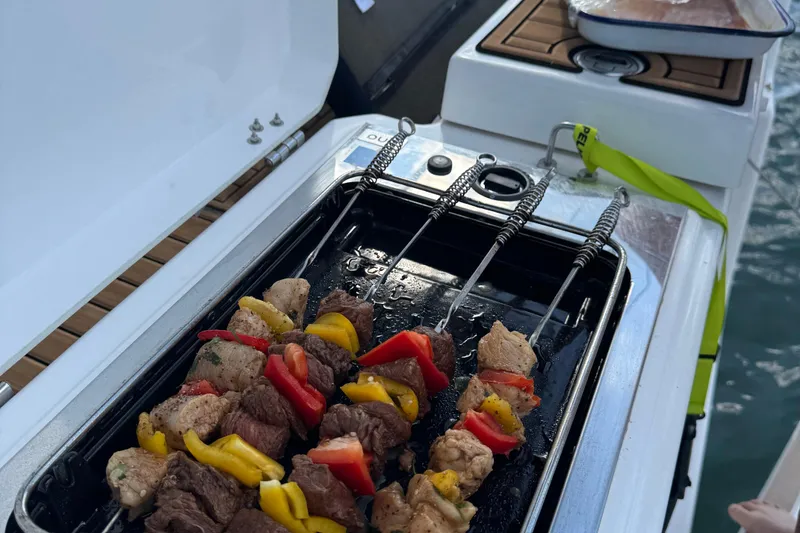 Slide: The Image of Grilling skewers on a Dufour 37 yacht, 2023 model, with vibrant vegetables and meat. - 29