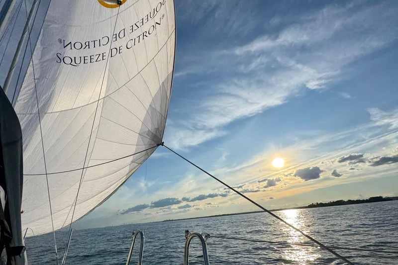 Slide: The Image of Sailing on a 2023 Dufour 37 yacht at sunset with billowing sails. - 30