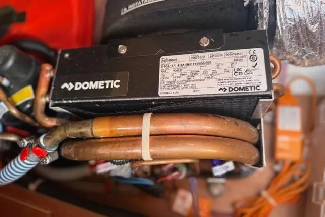 Slide: The Image of Dometic unit with copper pipes in a 2023 Dufour 37 yacht. - 31