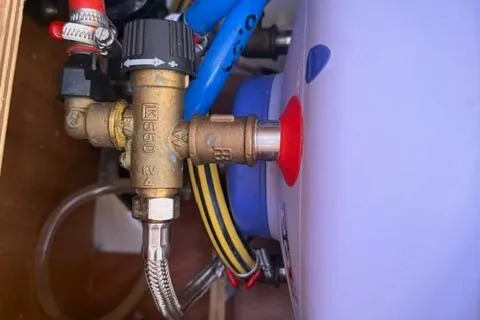 Slide: The Image of Plumbing system in 2023 Dufour 37 yacht, featuring brass fittings and hoses. - 32