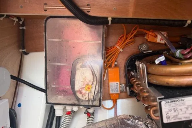 Slide: The Image of Electrical components inside a 2023 Dufour 37 yacht, featuring wiring and control systems. - 33