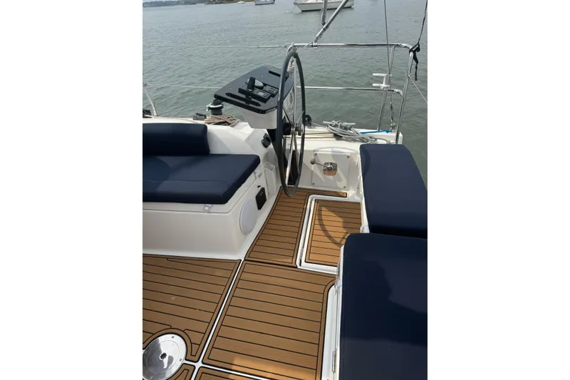 Slide: The Image of 2023 Dufour 37 yacht cockpit with teak flooring and navy seating. - 6