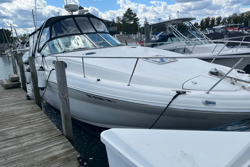 Slide: The Image of 2002 Sea Ray 320 Sundancer docked at marina under cloudy sky. - 1