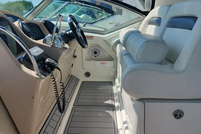 Slide: The Image of Interior of a 2002 Sea Ray 320 Sundancer boat with steering wheel and seating. - 14