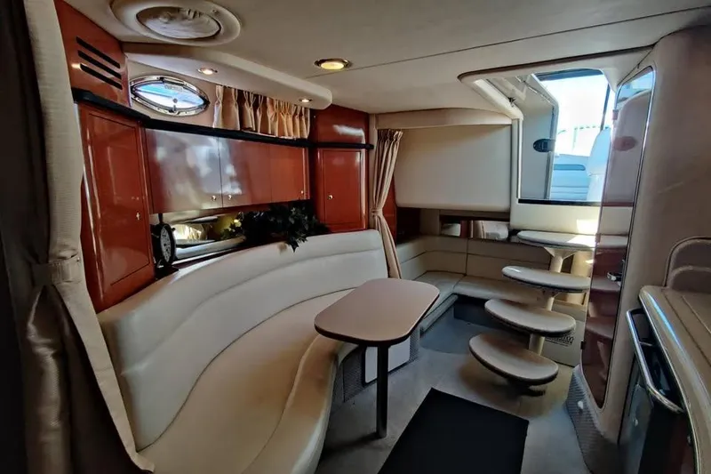Slide: The Image of Interior of 2002 Sea Ray 320 Sundancer yacht with elegant seating and cabinetry. - 18