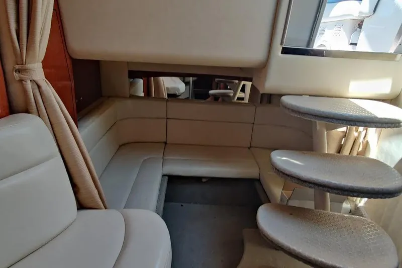 Slide: The Image of Interior of 2002 Sea Ray 320 Sundancer with beige seating and curved steps. - 19