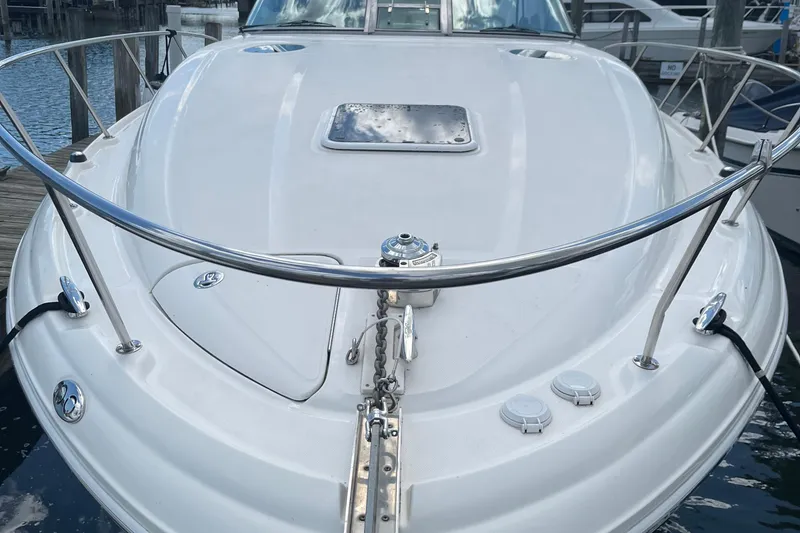Slide: The Image of 2002 Sea Ray 320 Sundancer boat deck with stainless steel railings and anchor chain. - 2