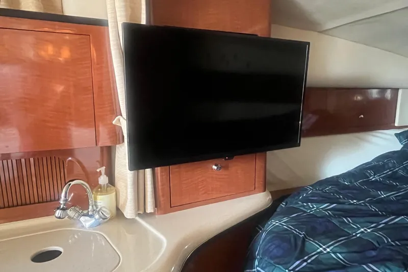 Slide: The Image of Interior of 2002 Sea Ray 320 Sundancer with TV, sink, and bed. - 25