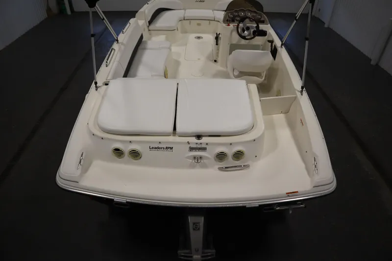 Slide: The Image of 2007 Glastron 205 DS boat interior with white seating and steering console. - 10