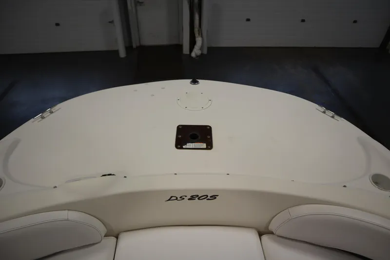 Slide: The Image of 2007 Glastron 205 DS boat interior, featuring white seating and deck details. - 11