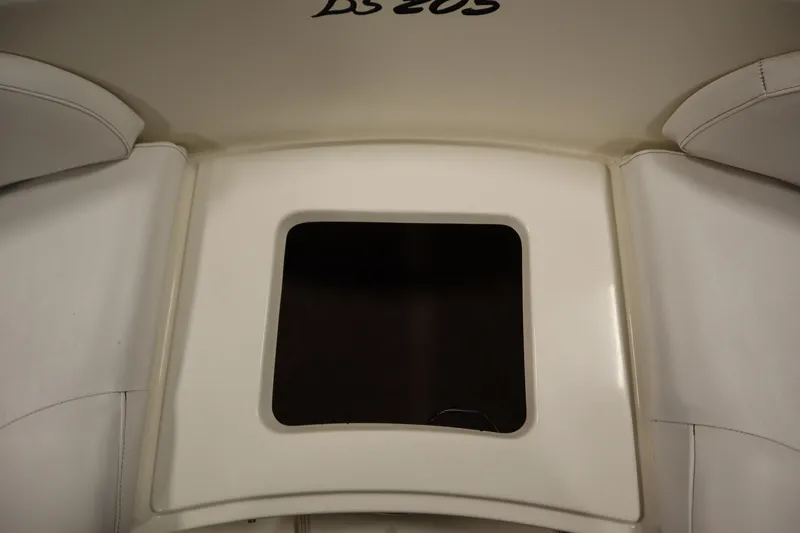 Slide: The Image of 2007 Glastron 205 DS boat interior seating area with storage compartment. - 13