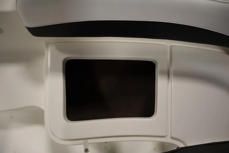 Slide: The Image of 2007 Glastron 205 DS boat interior storage compartment, white and black design. - 15