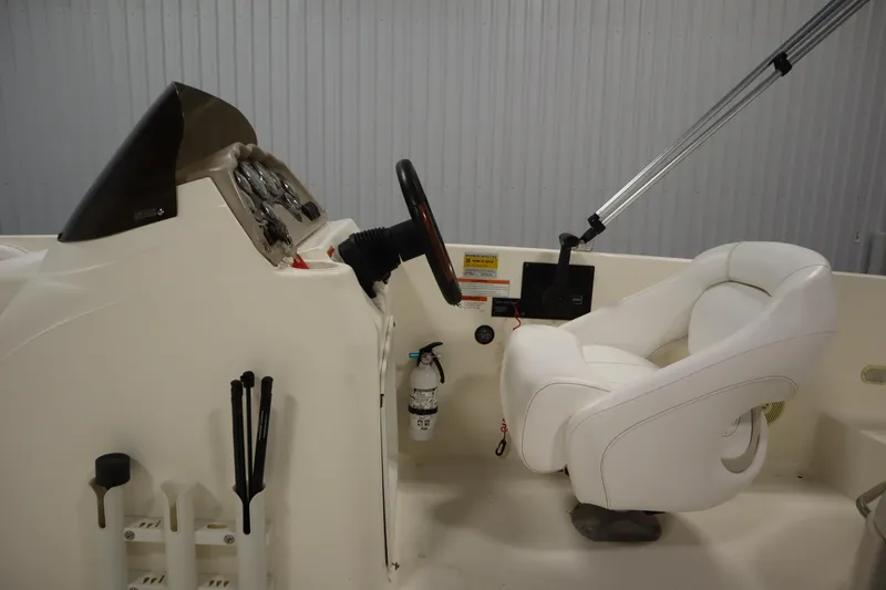 Slide: The Image of 2007 Glastron 205 DS boat cockpit with steering wheel and white captain's chair. - 18
