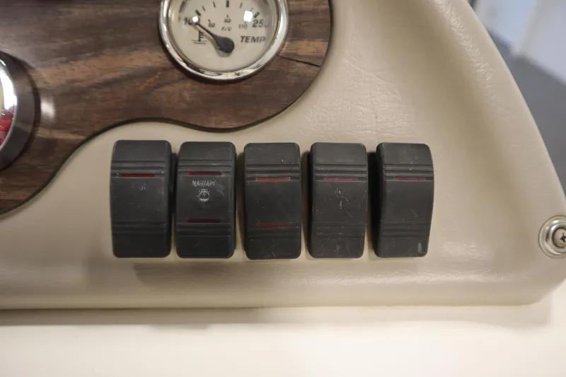 Slide: The Image of Dashboard switches and temperature gauge on a 2007 Glastron 205 DS boat. - 23