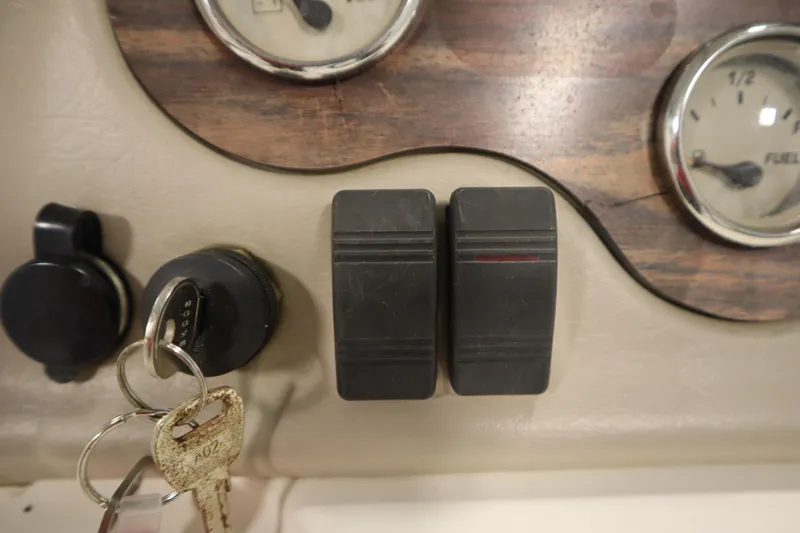 Slide: The Image of Dashboard of a 2007 Glastron 205 DS boat with ignition keys and fuel gauge. - 24