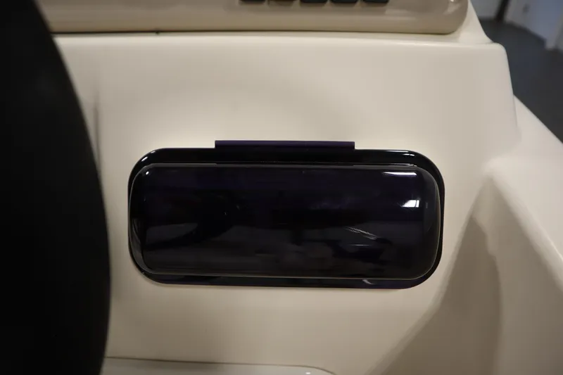 Slide: The Image of Dashboard detail of a 2007 Glastron 205 DS boat, featuring a dark panel. - 25