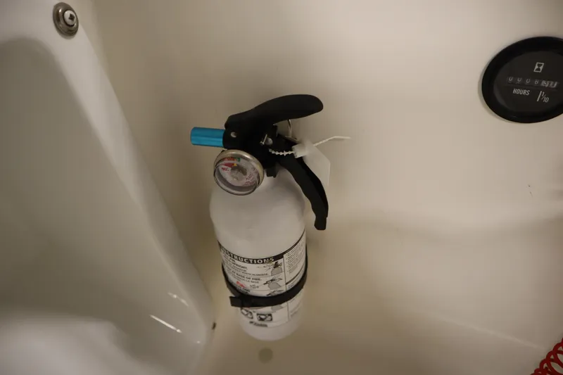 Slide: The Image of Fire extinguisher in 2007 Glastron 205 DS boat interior, near hour meter. - 27