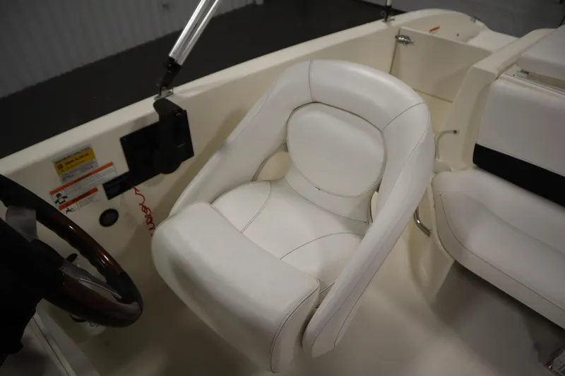 Slide: The Image of 2007 Glastron 205 DS boat interior with white captain's chair and steering wheel. - 29