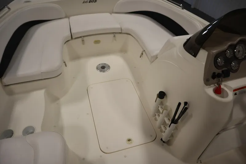 Slide: The Image of 2007 Glastron 205 DS boat interior with white seating and control panel. - 31