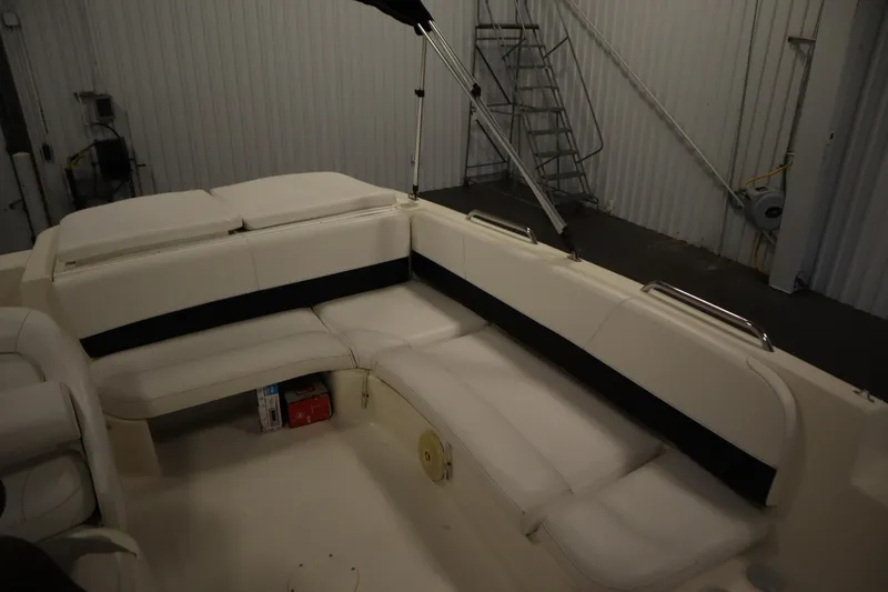 Slide: The Image of 2007 Glastron 205 DS boat interior with white seating in a storage facility. - 33