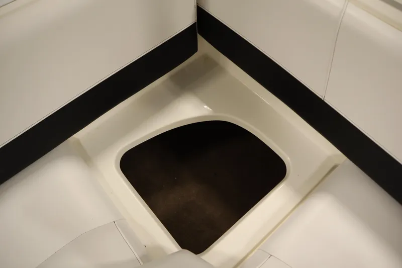 Slide: The Image of 2007 Glastron 205 DS boat interior storage compartment, white and black design. - 35