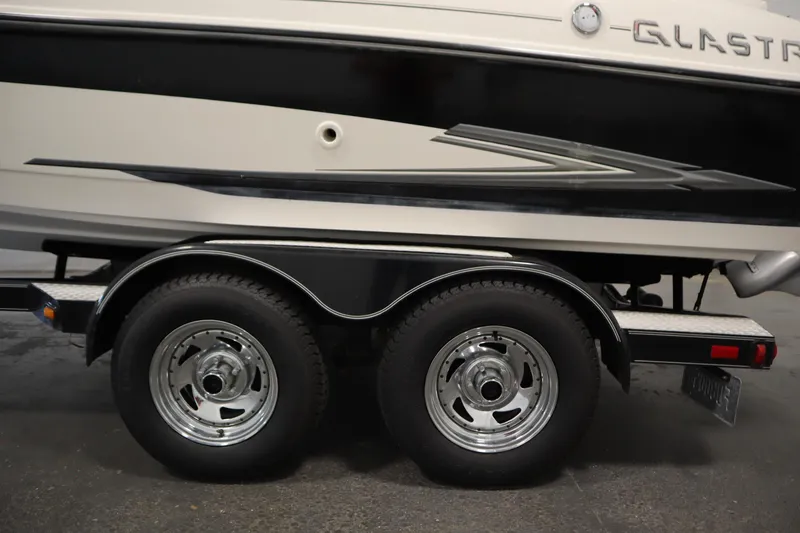 Slide: The Image of 2007 Glastron 205 DS boat on trailer with dual wheels and sleek design. - 43