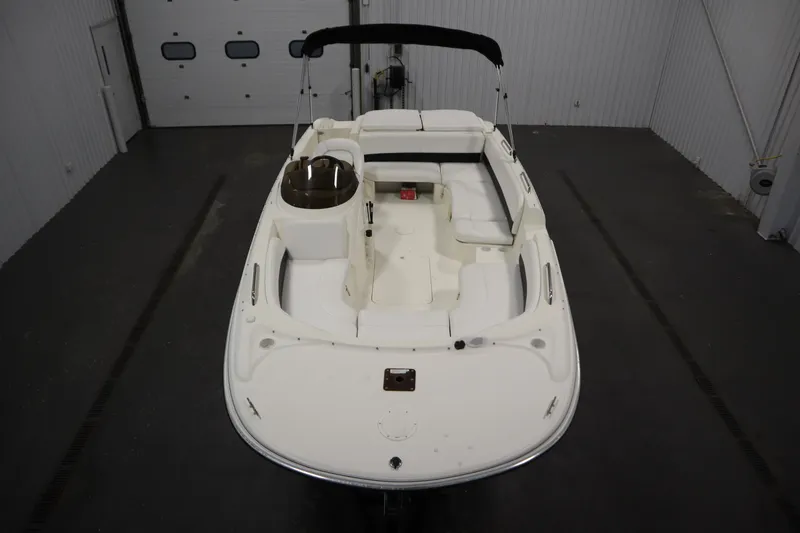 Slide: The Image of 2007 Glastron 205 DS boat in indoor storage, featuring spacious seating and sleek design. - 9