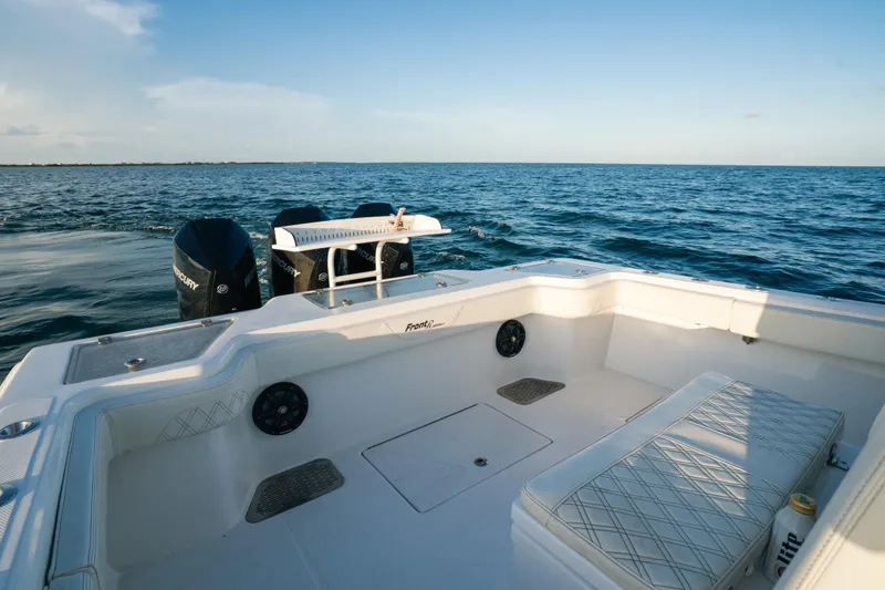 Slide: The Image of 2023 Front Runner 36 Center Console boat on open water, featuring spacious seating and dual engines. - 11