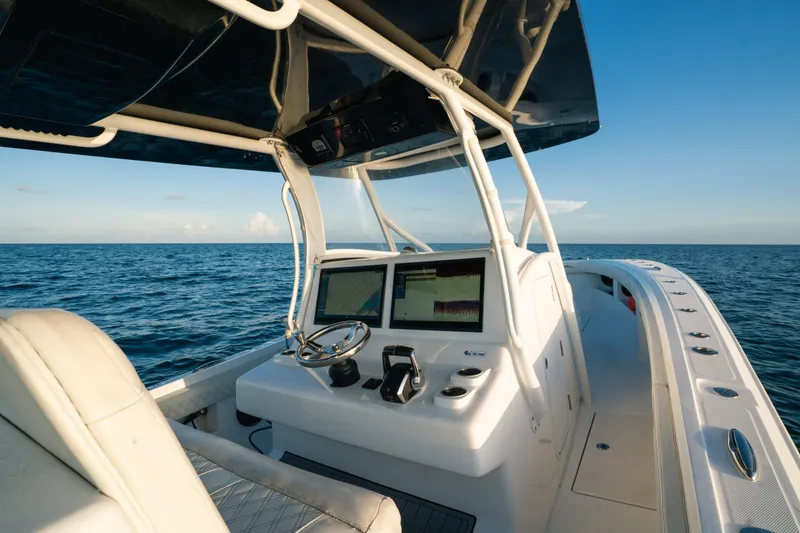 Slide: The Image of 2023 Front Runner 36 Center Console boat on open sea, featuring modern navigation equipment. - 16