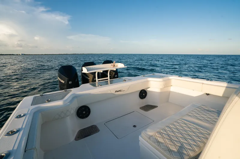 Slide: The Image of 2023 Front Runner 36 Center Console boat on open water, showcasing spacious seating and dual engines. - 17