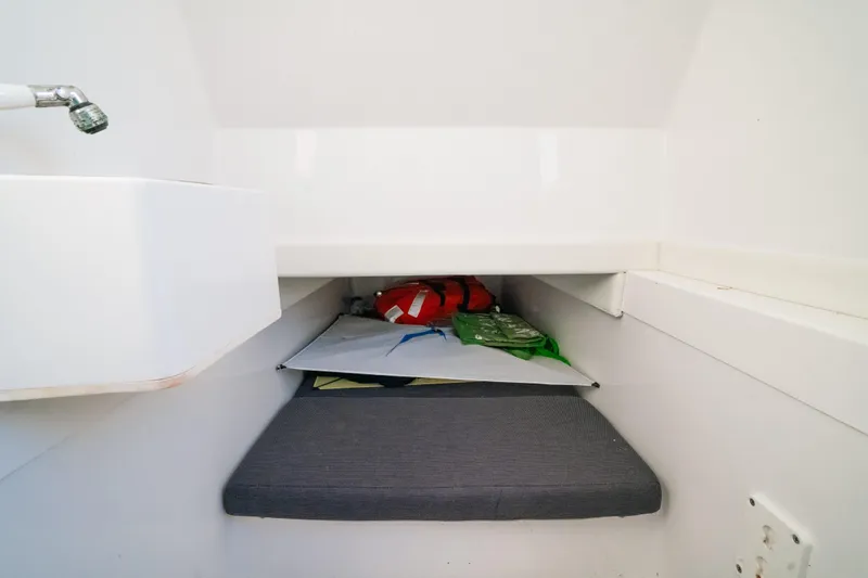 Slide: The Image of 2023 Front Runner 36 Center Console cabin interior with storage and seating area. - 25