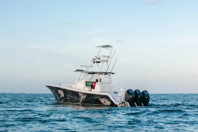 Slide: The Image of 2023 Front Runner 36 Center Console boat on open water, featuring triple outboard engines. - 29