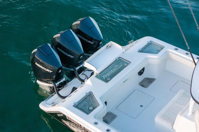 Slide: The Image of 2023 Front Runner 36 Center Console with triple Mercury outboard engines on water. - 3