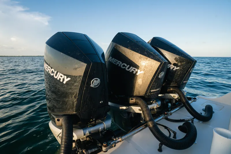 Slide: The Image of Triple Mercury outboard engines on a 2023 Front Runner 36 Center Console boat in open water. - 6