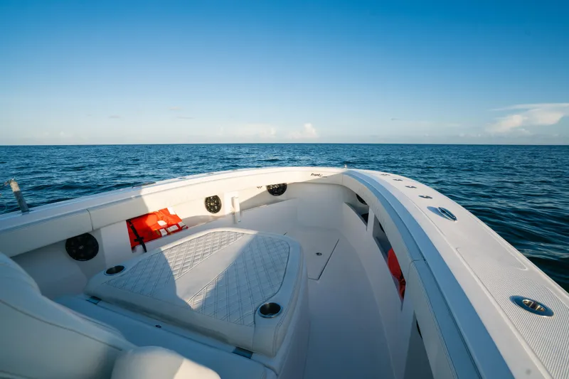 Slide: The Image of 2023 Front Runner 36 Center Console boat on open sea, clear sky, spacious deck. - 9