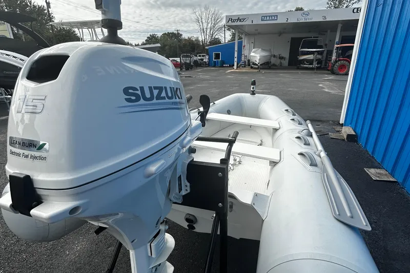 Slide: The Image of 2019 Brig Falcon 300 inflatable boat with Suzuki outboard motor in a dealership lot. - 10