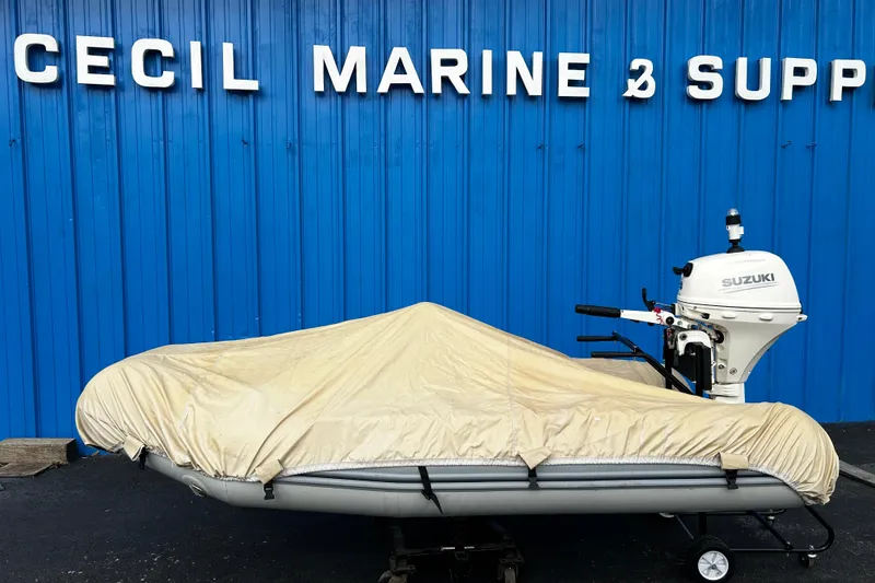 Slide: The Image of 2019 Brig Falcon 300 boat covered, with Suzuki outboard, at Cecil Marine & Supply. - 14