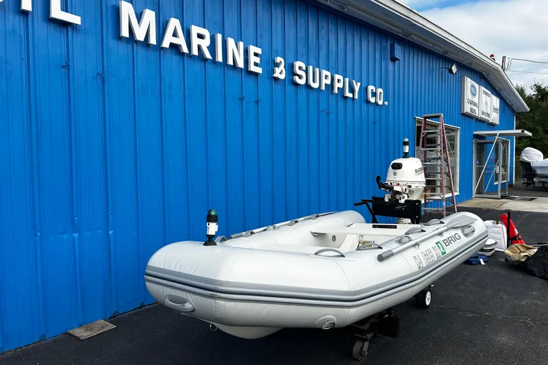 Slide: The Image of 2019 Brig Falcon 300 inflatable boat outside marine supply store. - 2