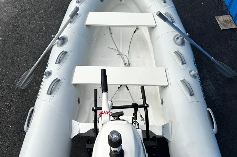 Slide: The Image of 2019 Brig Falcon 300 inflatable boat with oars and motor, viewed from above. - 4