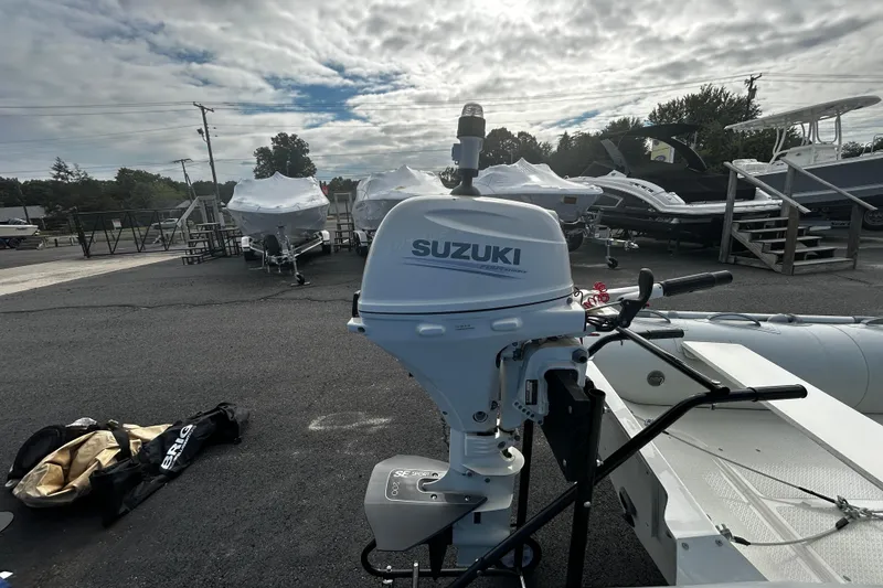 Slide: The Image of 2019 Brig Falcon 300 with Suzuki outboard motor in a boatyard under cloudy sky. - 7