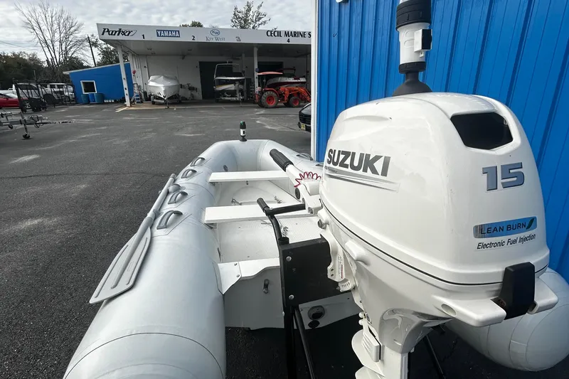 Slide: The Image of 2019 Brig Falcon 300 inflatable boat with Suzuki 15HP outboard motor at a marine dealership. - 9