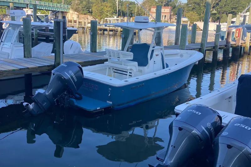 Slide: The Image of 2017 Regulator 23 Forward Seating boat docked with Yamaha outboard engine. - 1