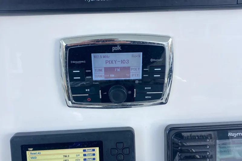 Slide: The Image of 2017 Regulator 23 Forward Seating boat docked in a marina, featuring a powerful outboard motor. - 11
